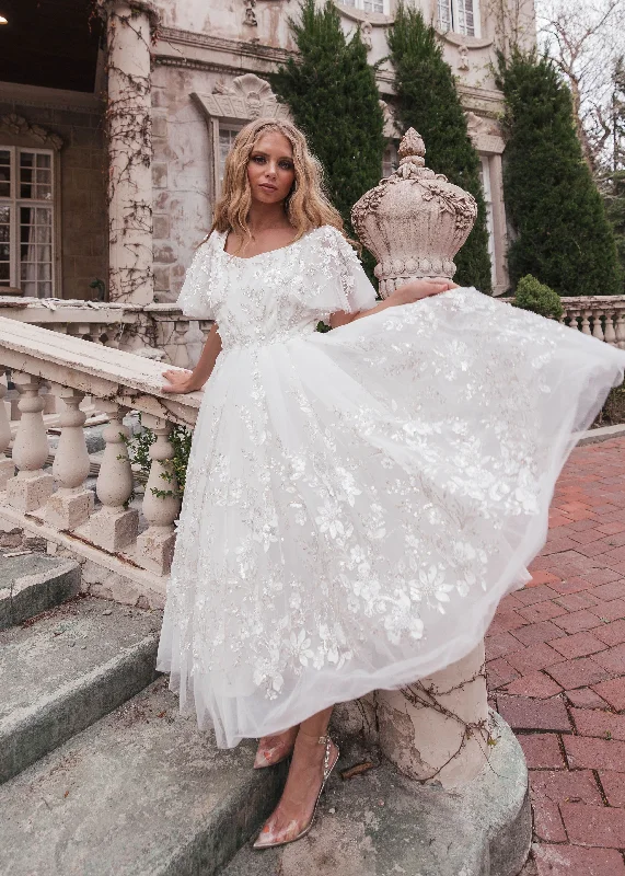 Midi dresses with pom - pom trims for a playful and festive look Misty Dress