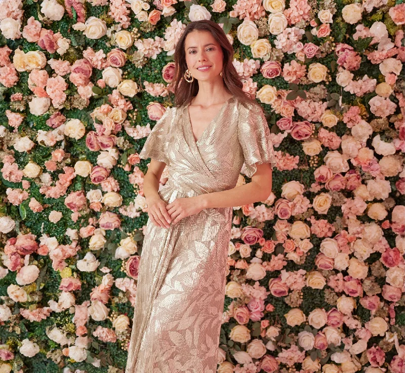 Maxi dresses with a criss - cross back for a flirty and unique detailFoil Leaf Short Sleeve Gown With Draped Details In Champagne Gold Maxi dresses with a criss - cross back for a flirty and unique detailFoil Leaf Short Sleeve Gown With Draped Details In Champagne Gold