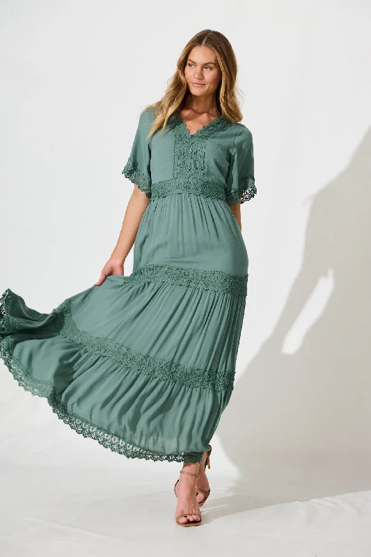 Maxi dresses with a criss - cross back for a flirty and unique detailMona Maxi Dress In Dark Sage Green Maxi dresses with a criss - cross back for a flirty and unique detailMona Maxi Dress In Dark Sage Green